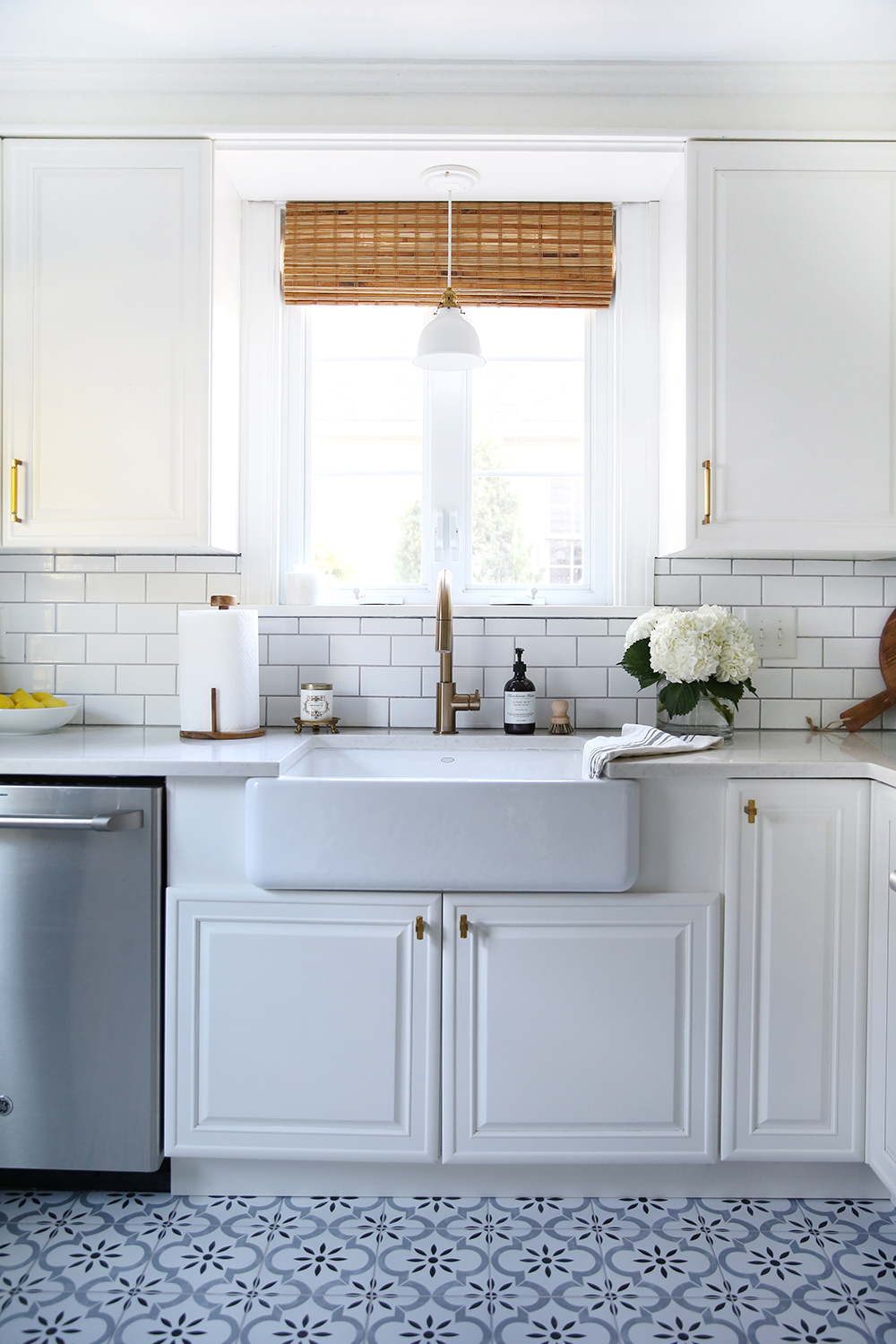 https://roomfortuesday.com/wp-content/uploads/2018/10/White-Kitchen-With-Blue-Patterned-Floors.jpg