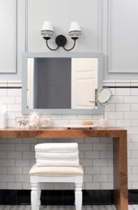 Double Sconce with DIY Ribbon on Shades above Burl Wood Bathroom Vanity