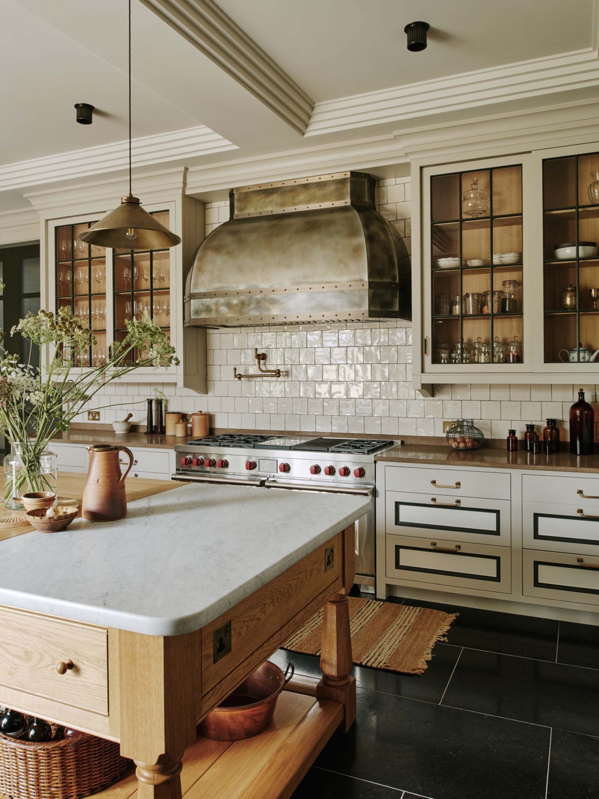 Wood-kitchen-island-with-marble-countertops-stainless-range-and-brass-hardware