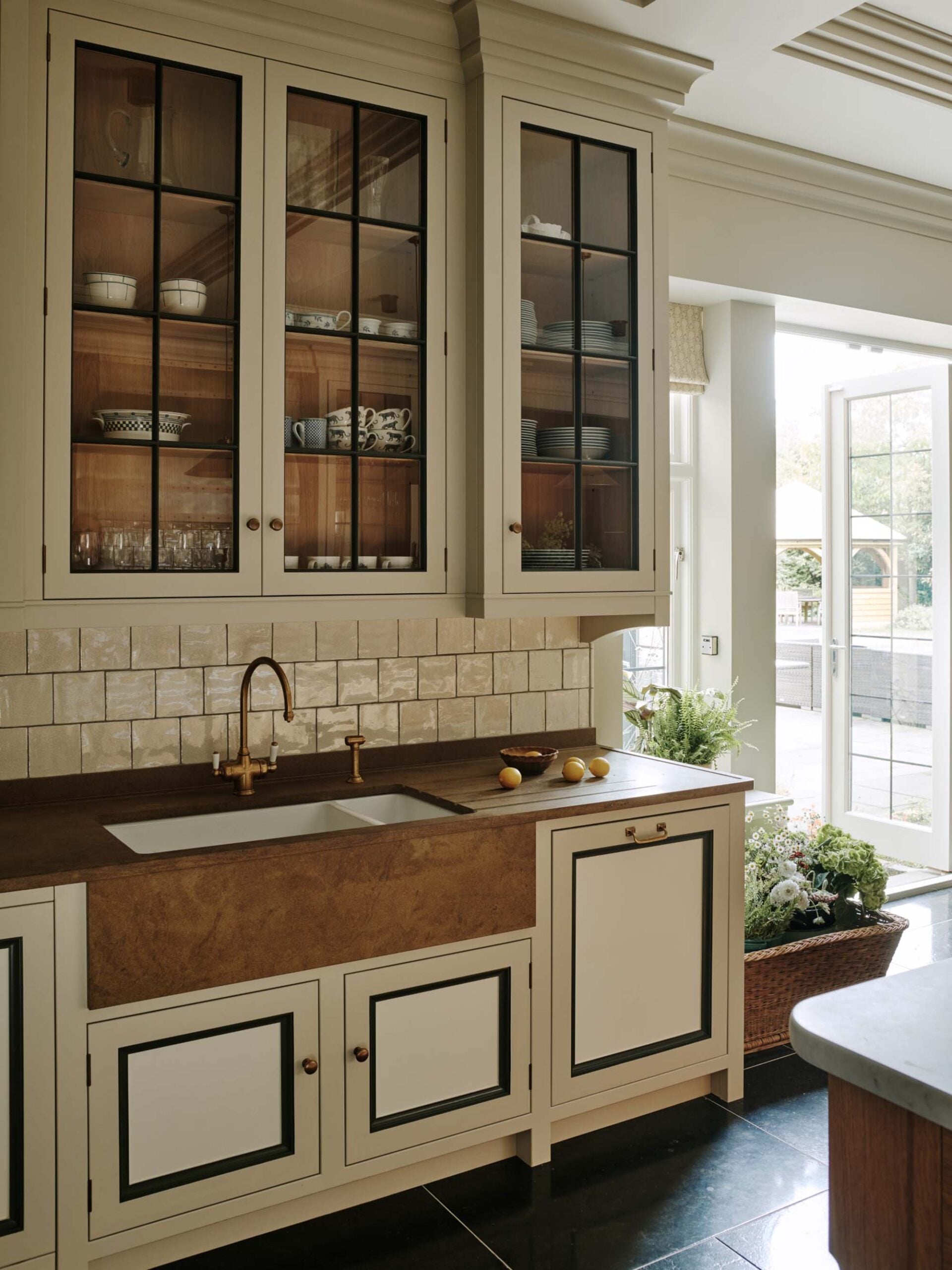 inset-kitchen-cabinetry-with-brass-faucet-and-hardware-sandstone-countertop