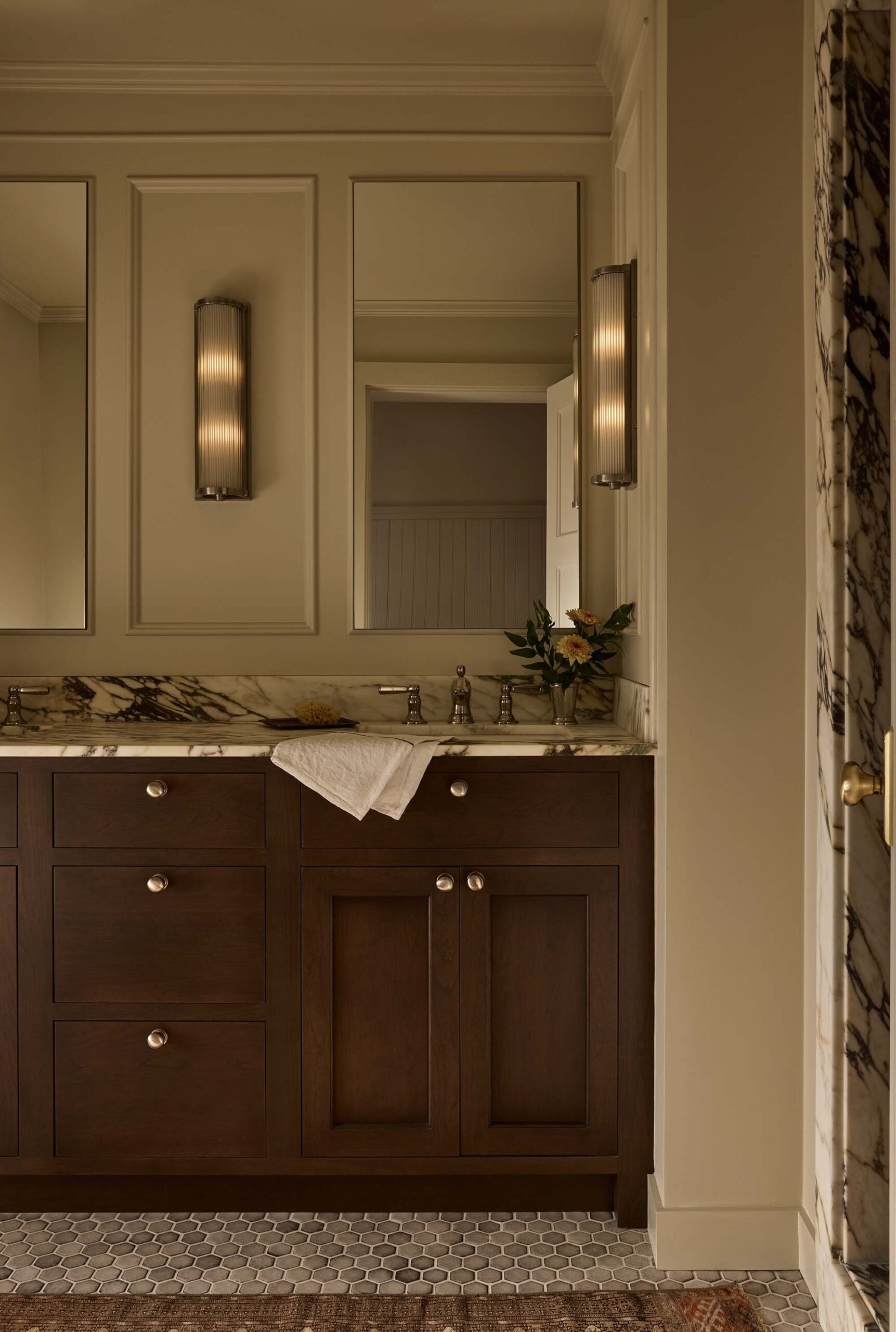 BATHROOM_vanity-with-marble-countertop-mirror-and-sconces