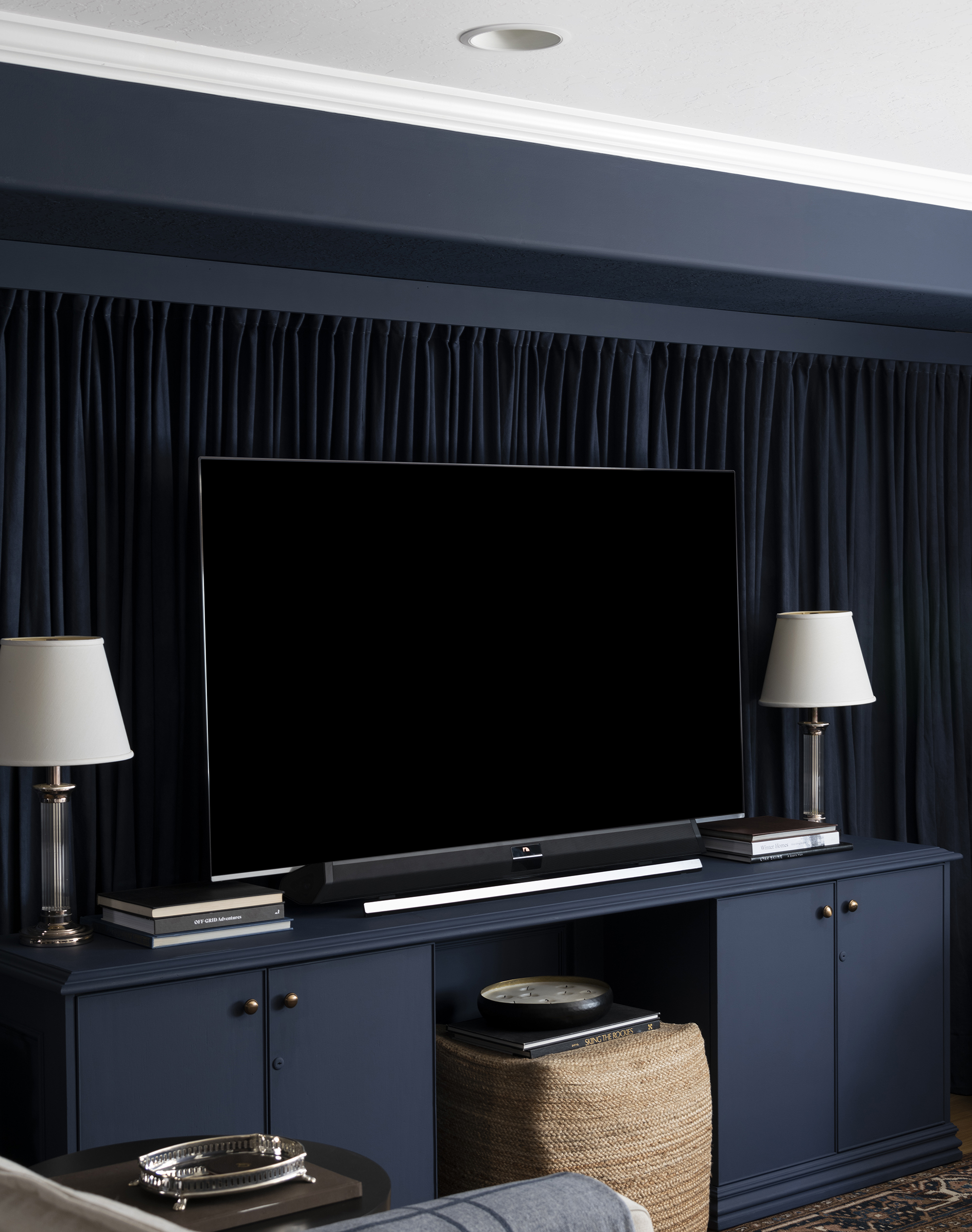 Basement Media Room with Large TV and Navy Curtains