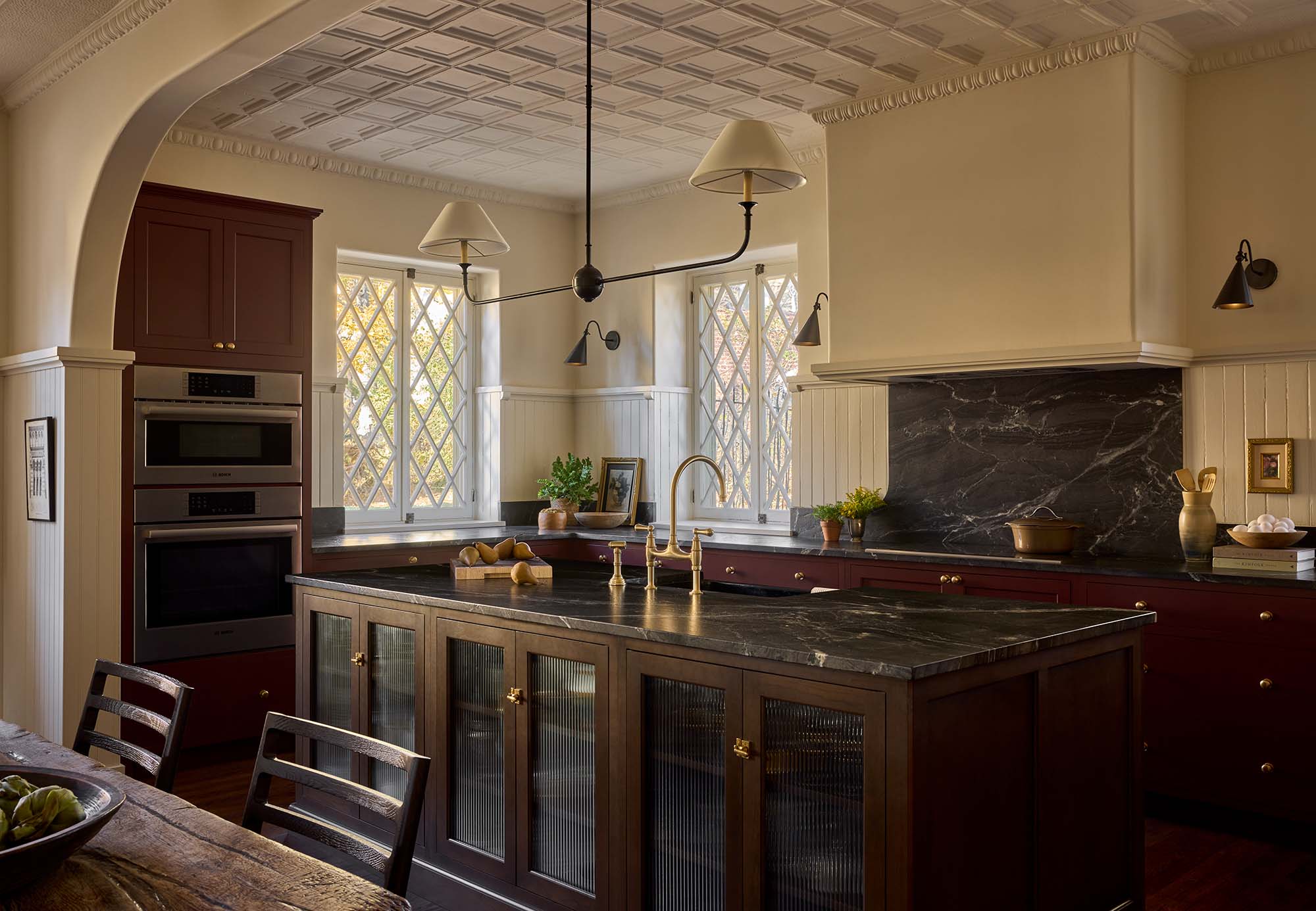 KITCHEN_sideview-including-island-with-sink-stacked-ovens-and-stovetop