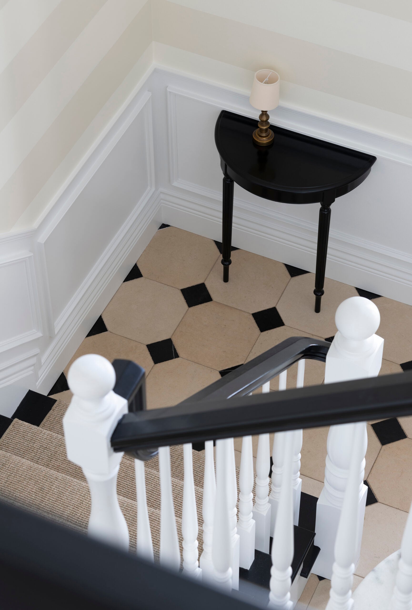 Black and White Staircase with Limestone Cabochon Flooring at Bottom