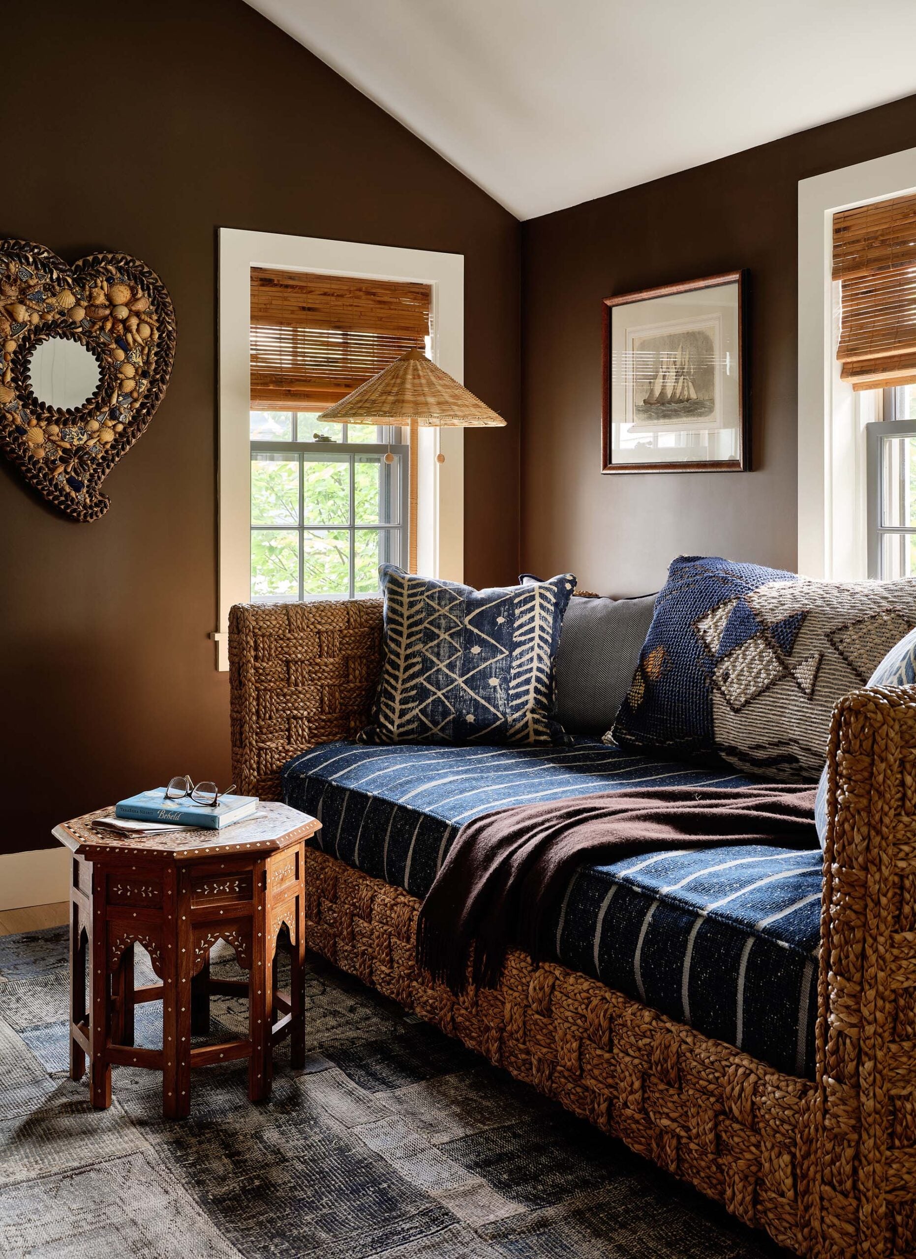 KristinPaton-Nantucket Rattan Daybed Windows with Woven Shades Artwork on Brown walls