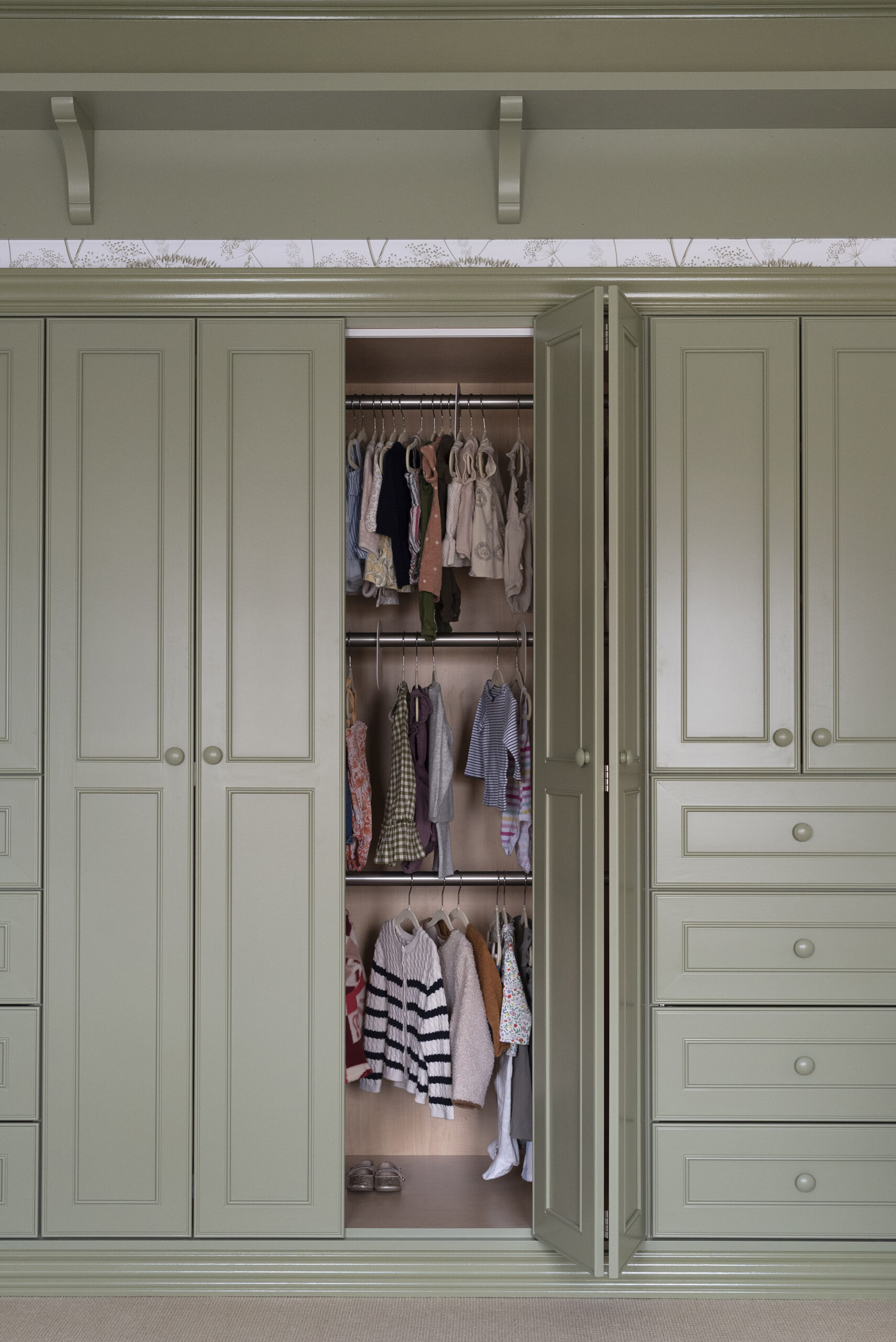 Green Built-In Closet in Nursery with Triple Clothes Rack
