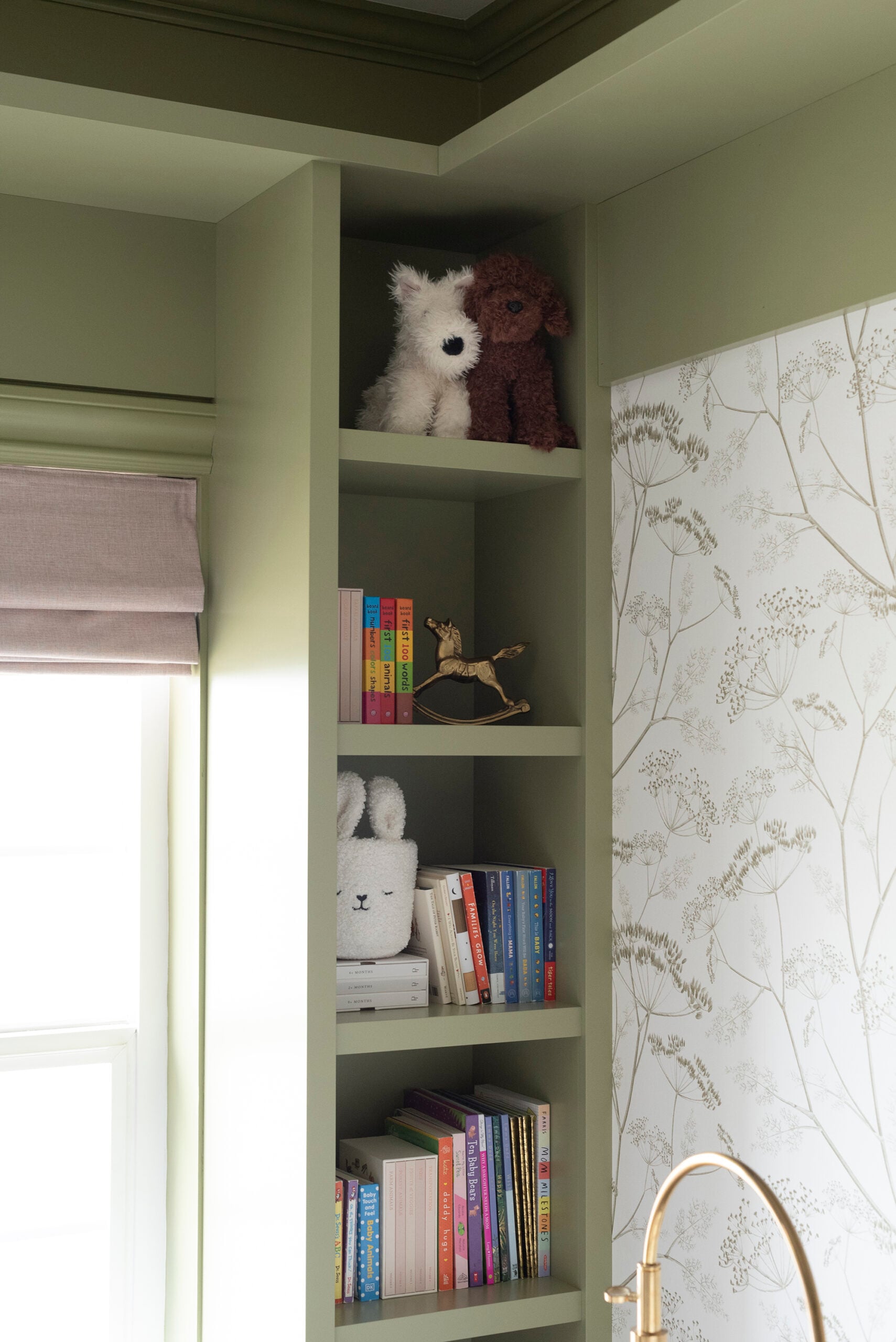 Green Built Ins in Floral Girl Nursery with Cute Stuffed Animals and Books