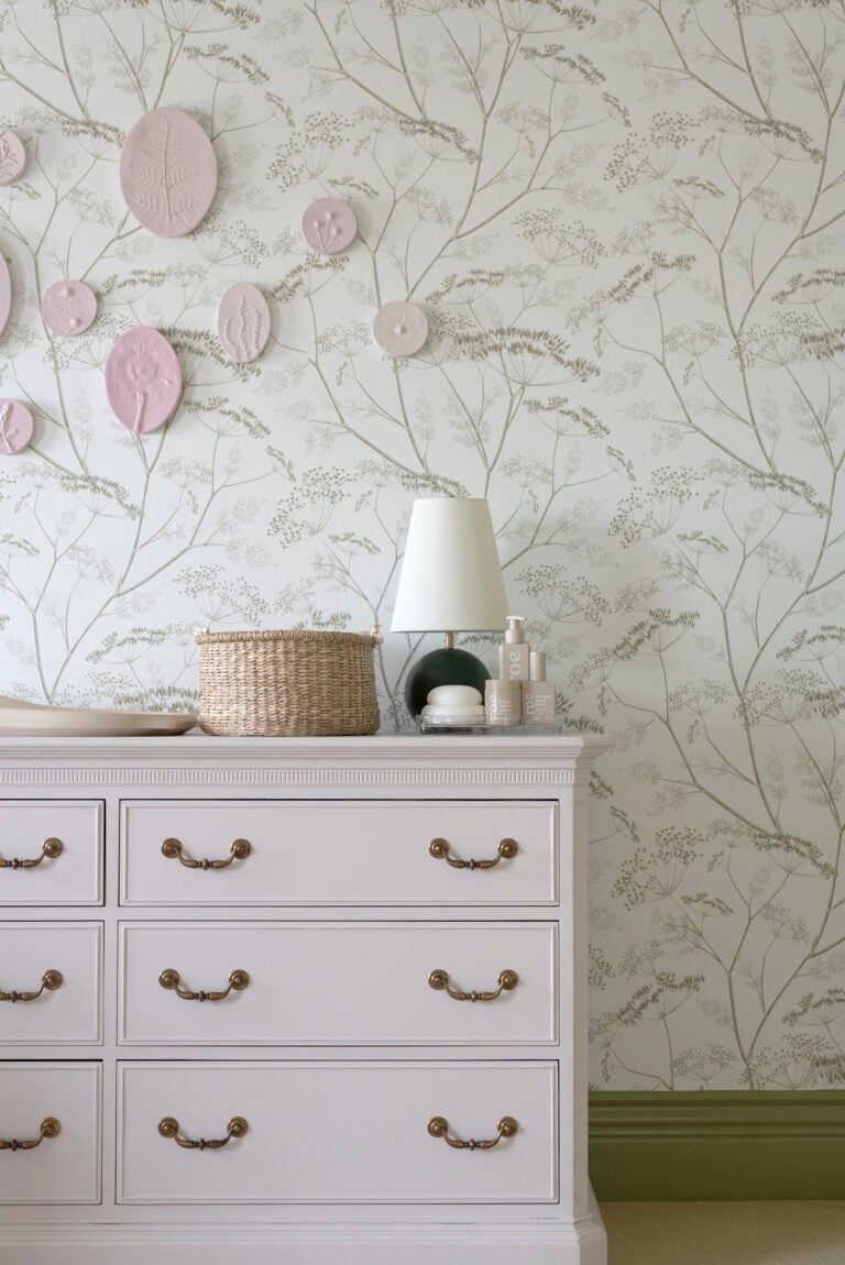 Light Pink Purple Dresser as Changing Table in Girl Nursery with Lamp and Diaper Caddy