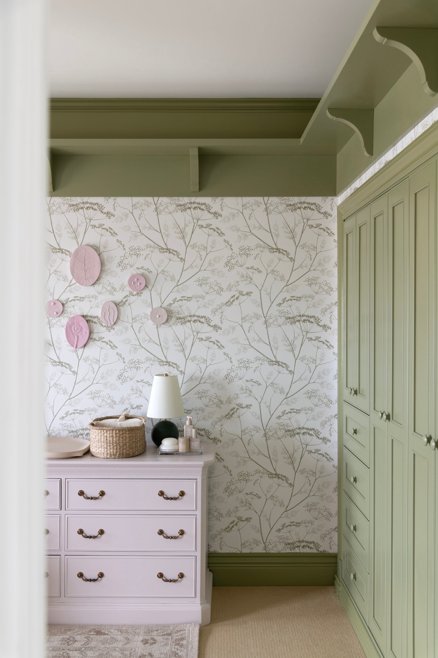 Light Purple Changing Station Dresser in Girl Nursery with Green Shelf and Closet Built-In