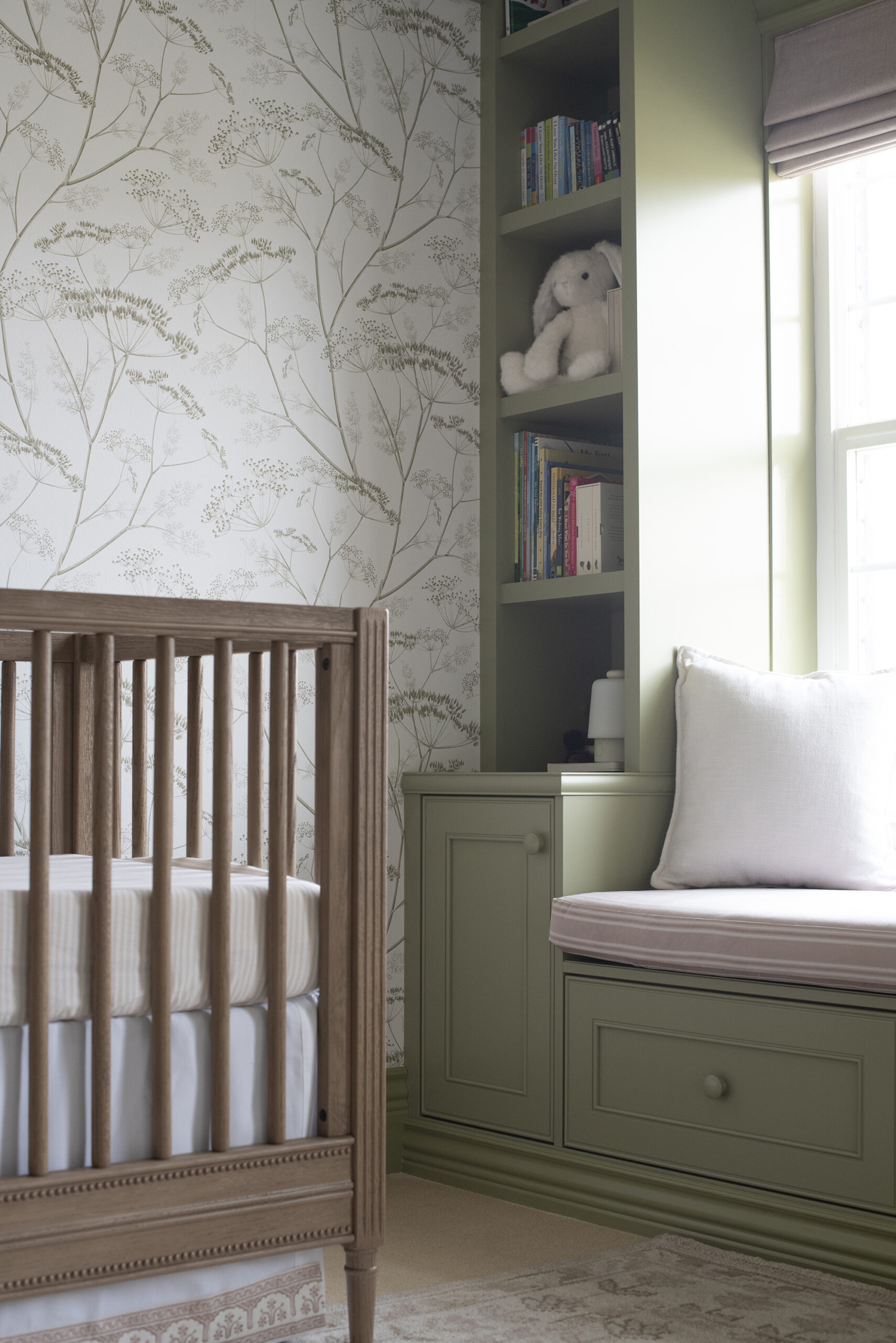 Striped Sheets in Baby Crib with Green Bench Seat and Built-Ins