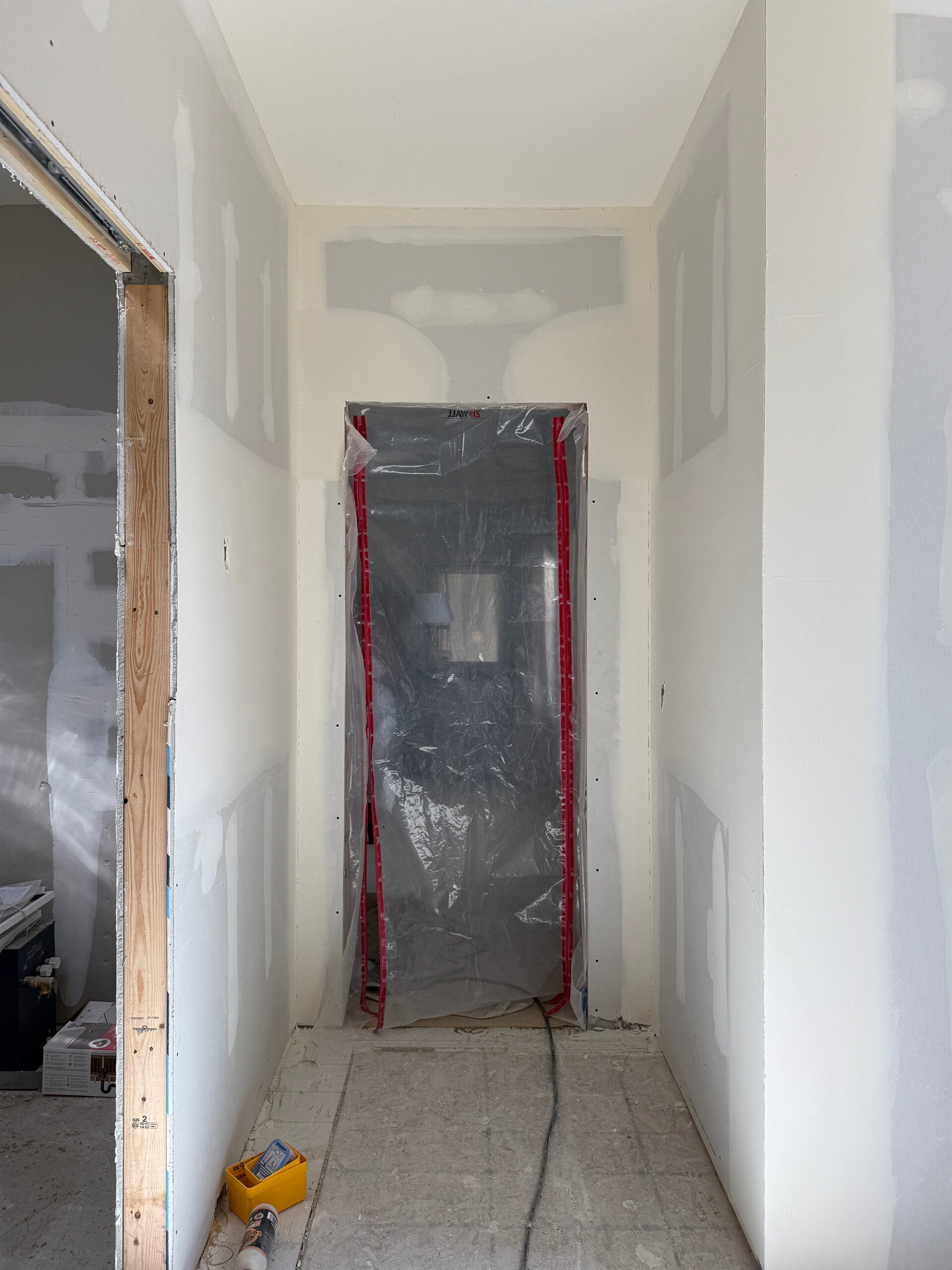 Drywall in Bathroom Remodel with Plastic Door