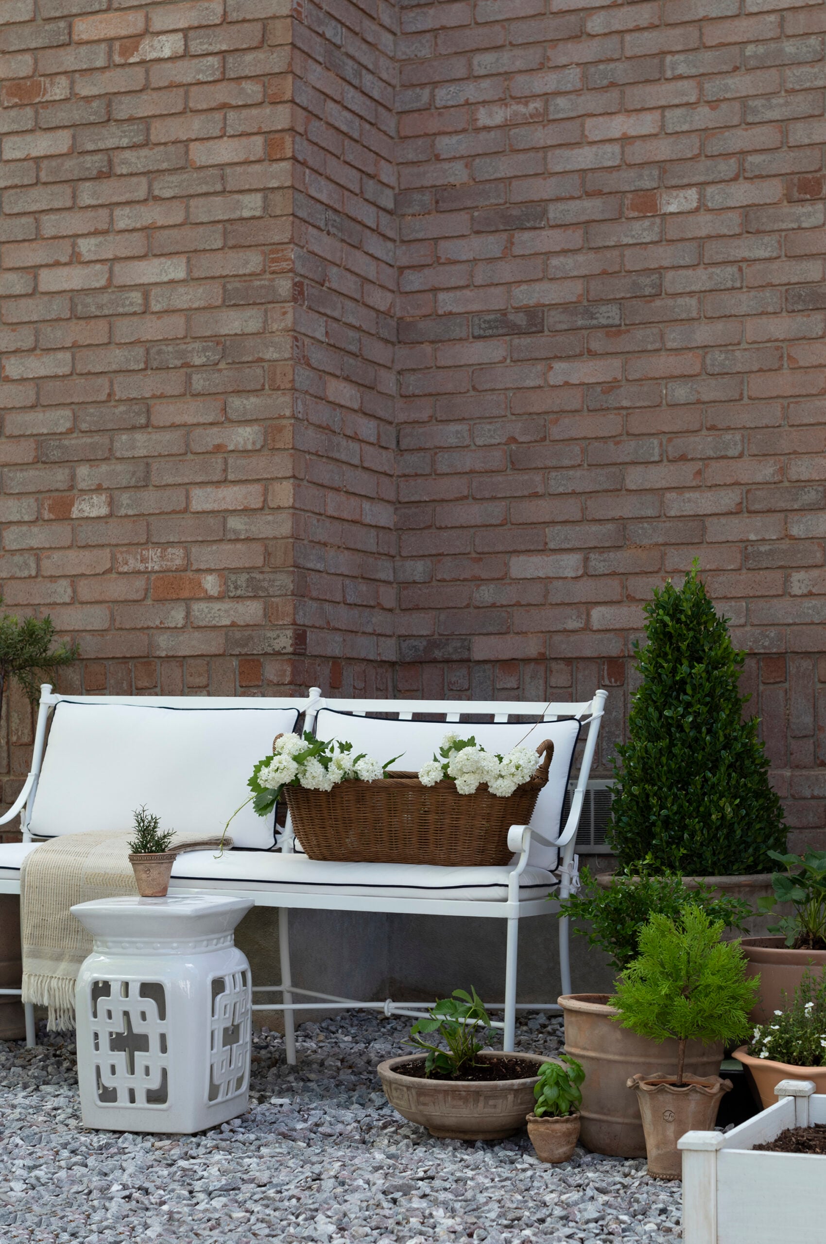 Garden Bench on Marble Chip Pea Gravel with Potted Plants