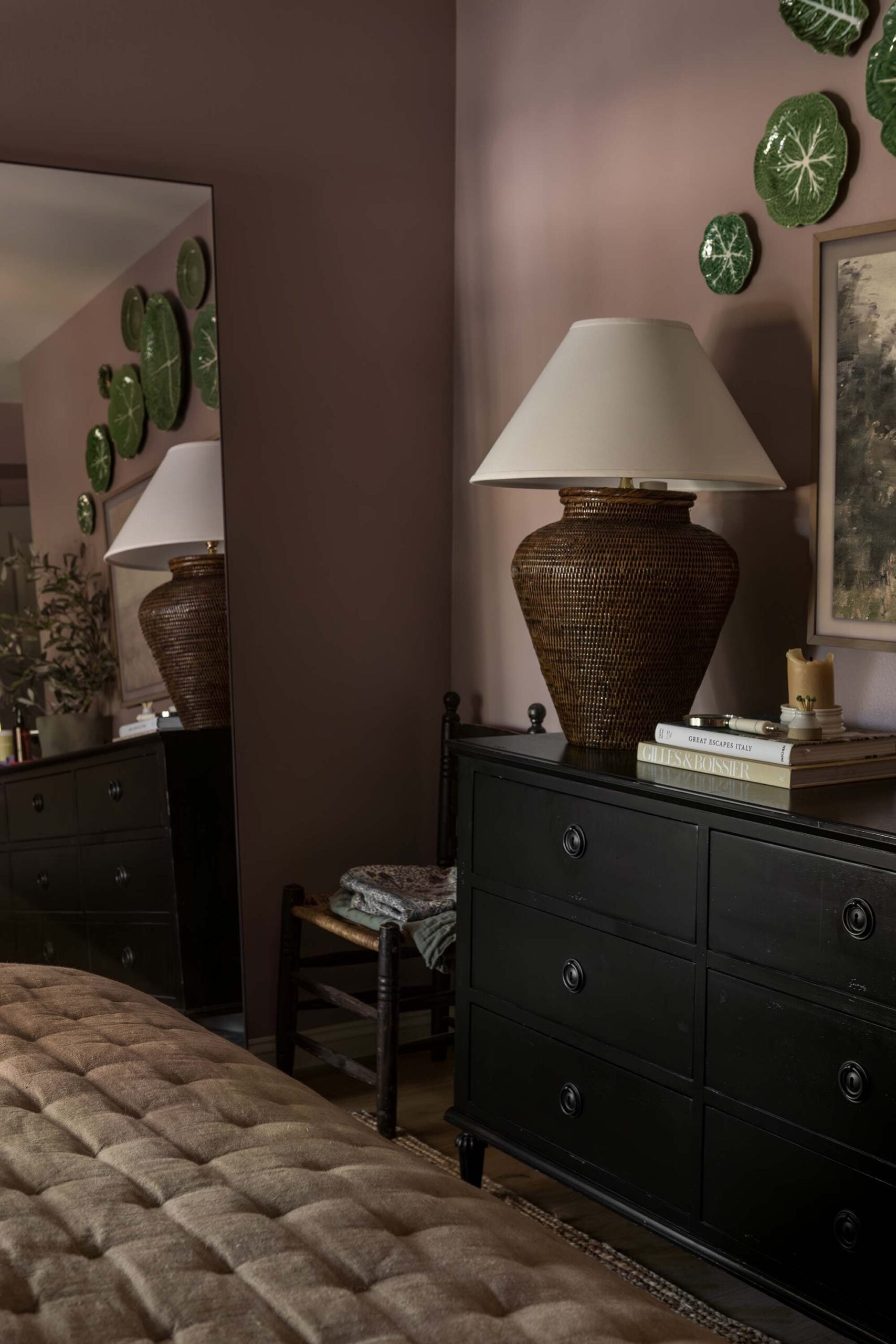 Oho Interiors-Carriage House-Bedroom dresser with woven lamp and cabbage plates on the wall