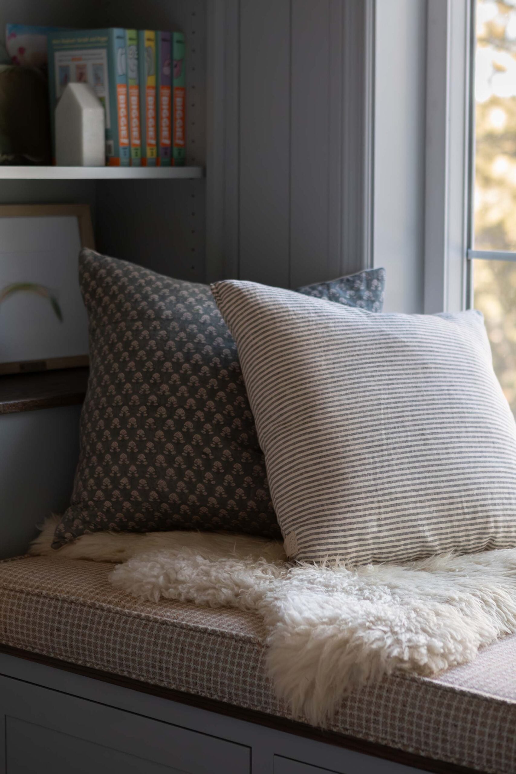 Oho Interiors-Carriage House-Built In book shelf and bench seat bedroom reading nook