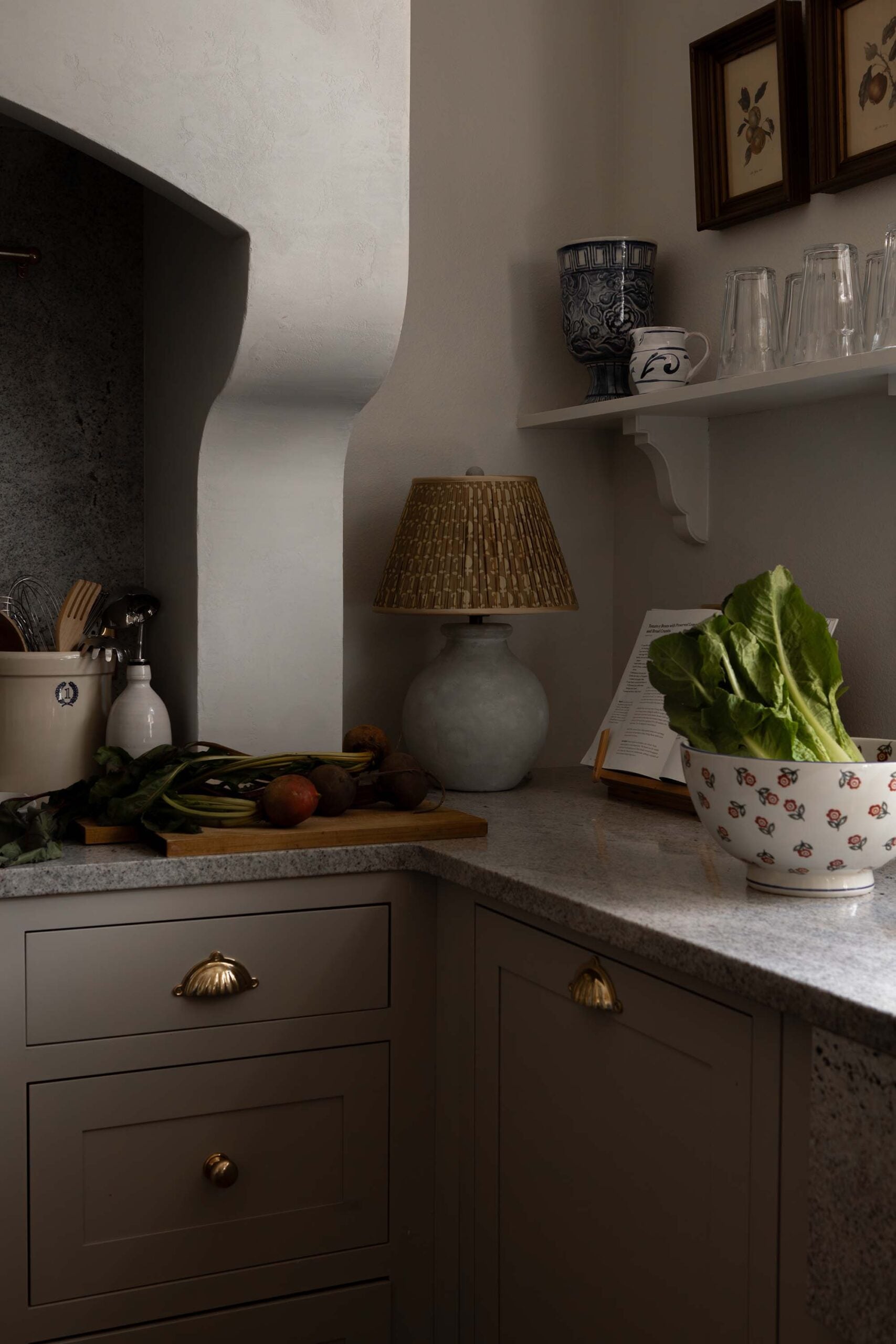 Oho Interiors-Carriage House-Kitchen Corner with range hood lamp and bowl on stone counter