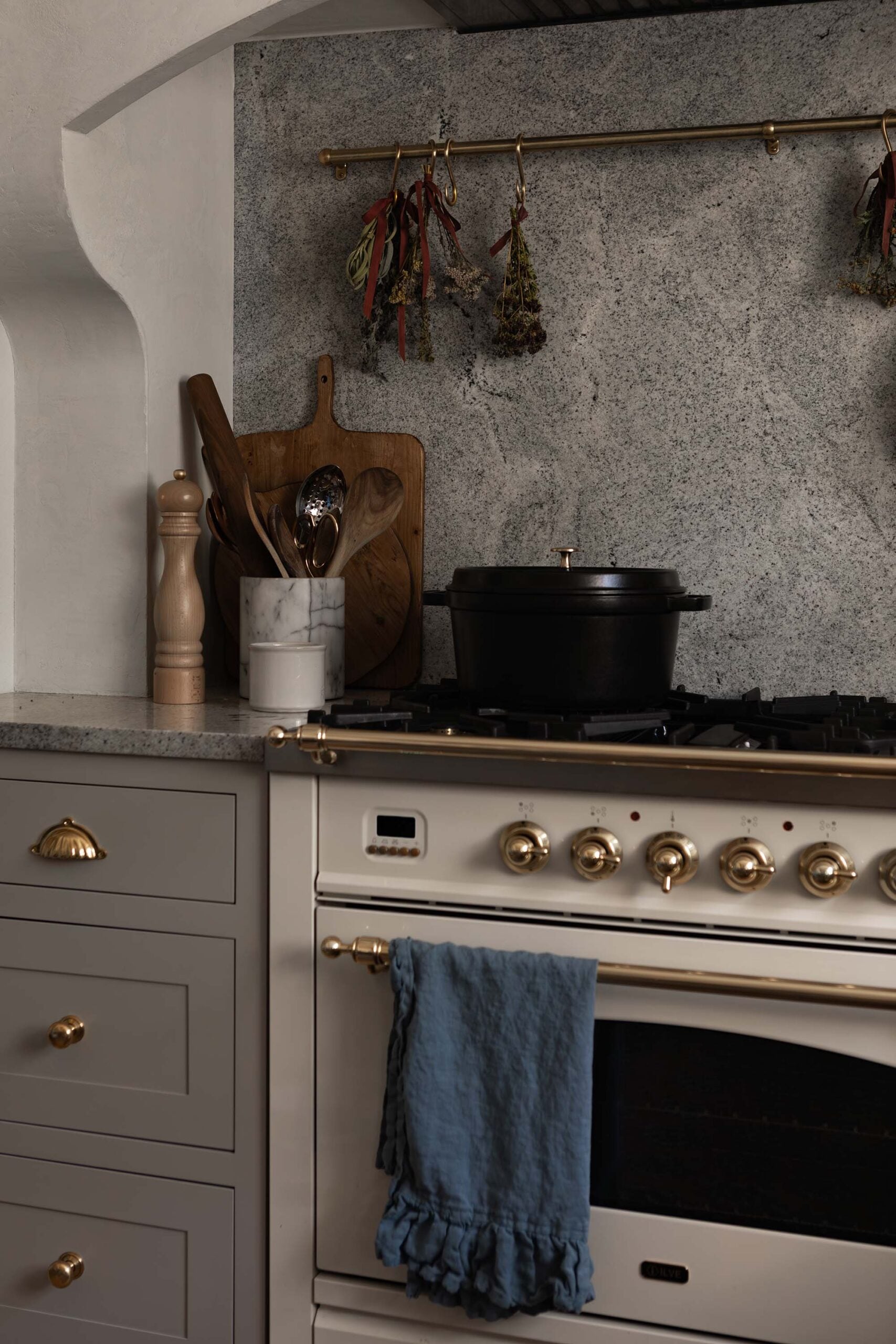 Oho Interiors-Carriage House-White Gas Range close-up with brass hardware