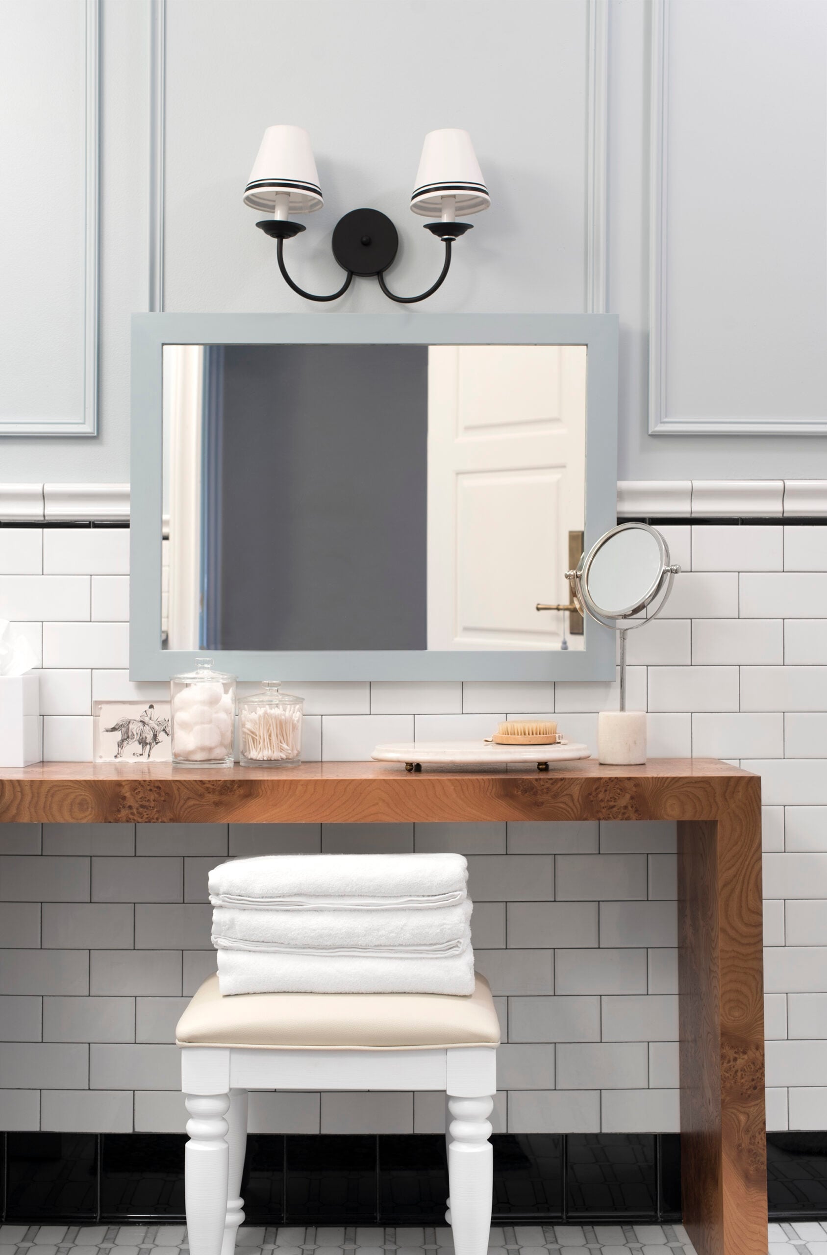 Burl Vanity Table with Ottoman and Towels in Guest Bathroom