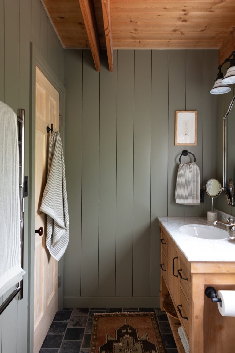 Cabin Bathroom with Wood Vanity and Green Paneled Walls