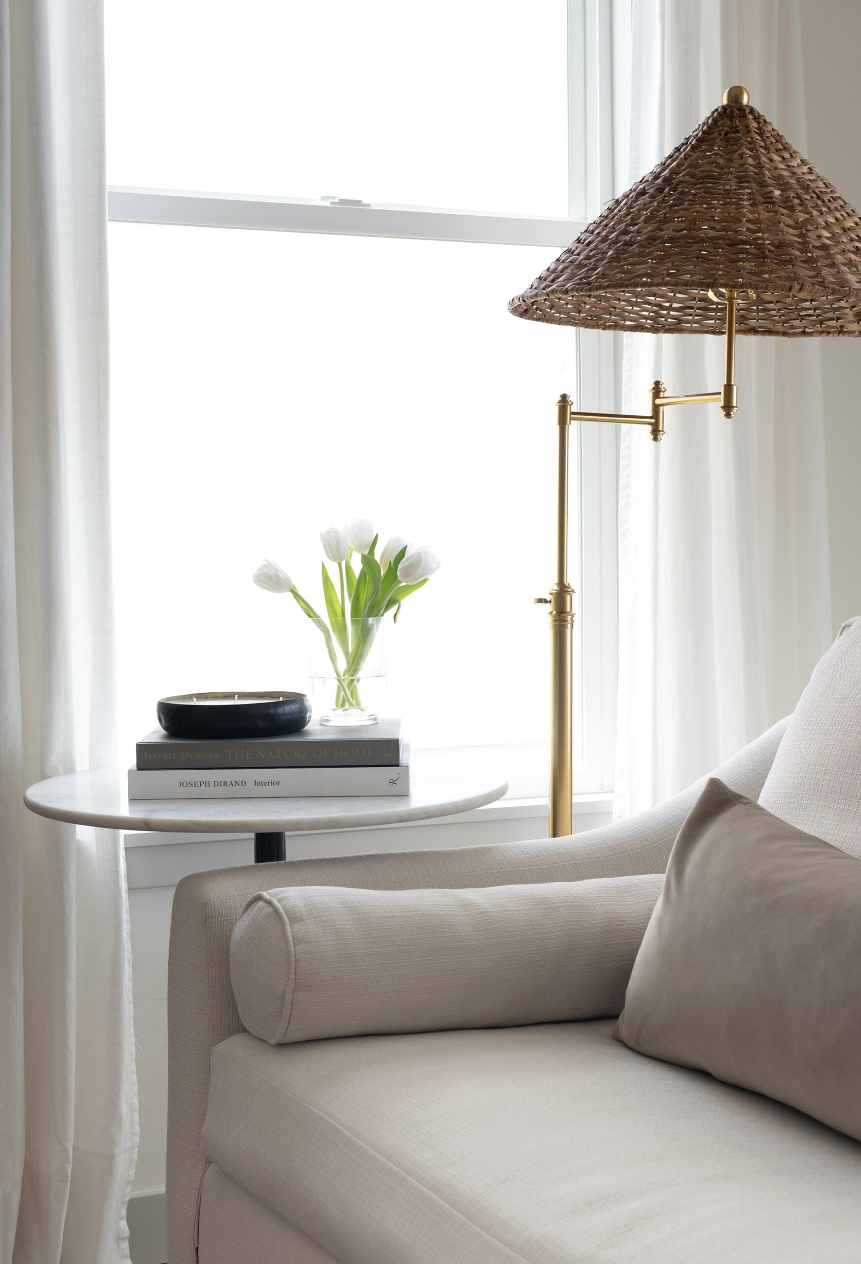 Neutral Sofa with Woven Lampshade in Front of Living Room Window