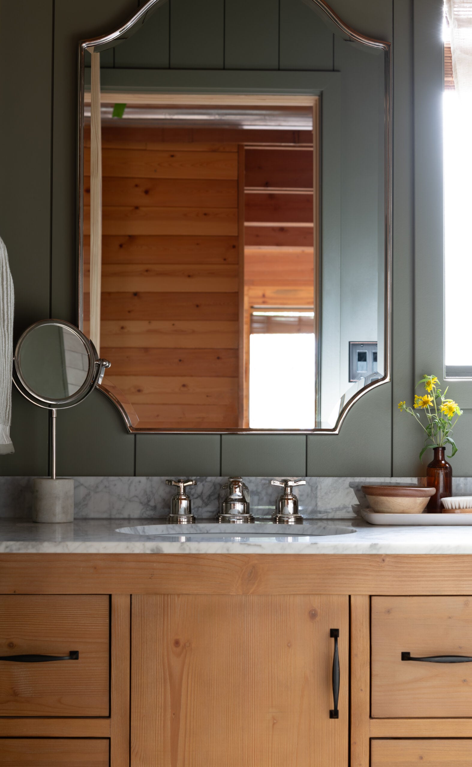 Polished Nickel Mirror Above Wood Vanity in Cabin Bathroom