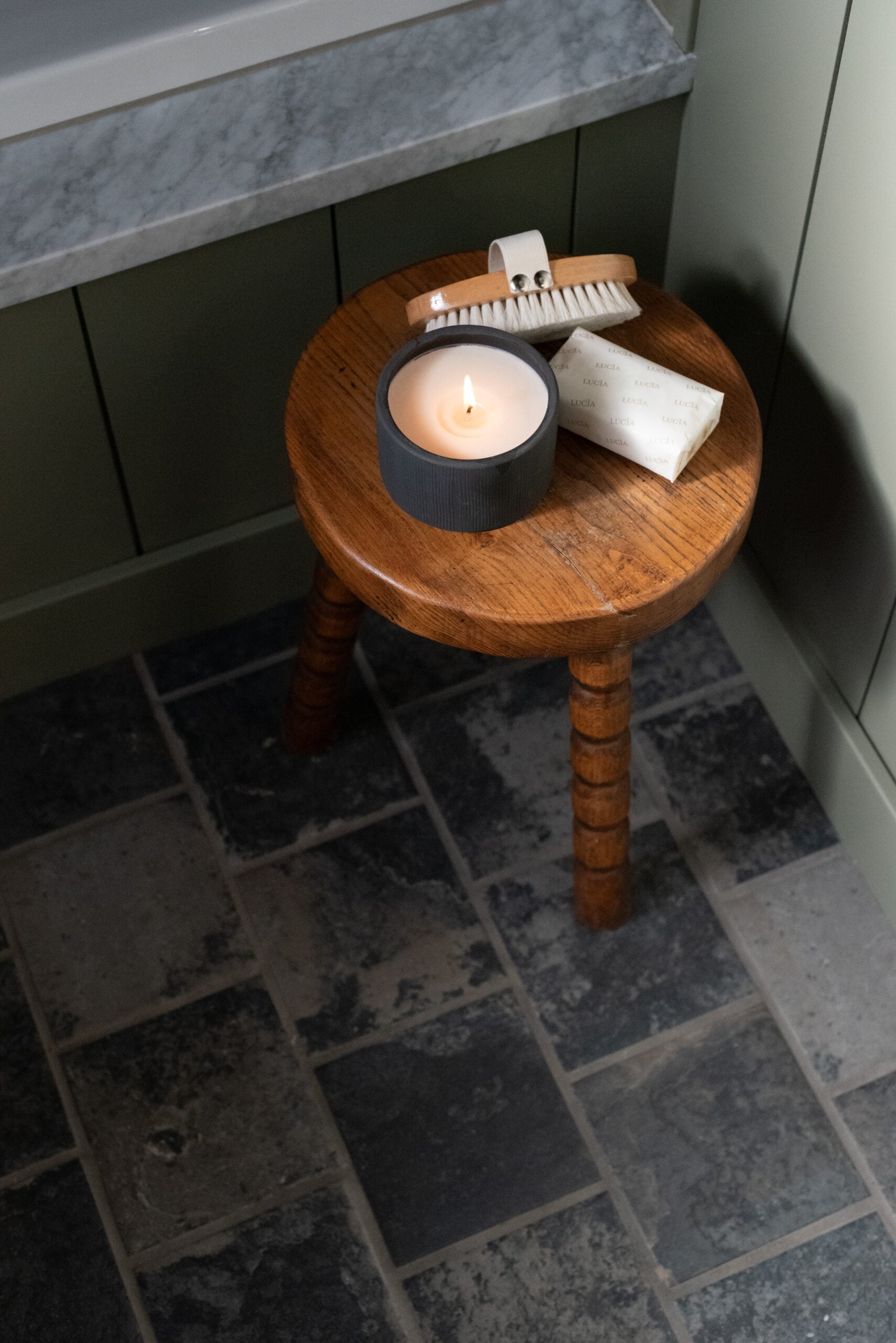 Wood Stool with Candle and Soap in Bathroom on Slate Floor Tile