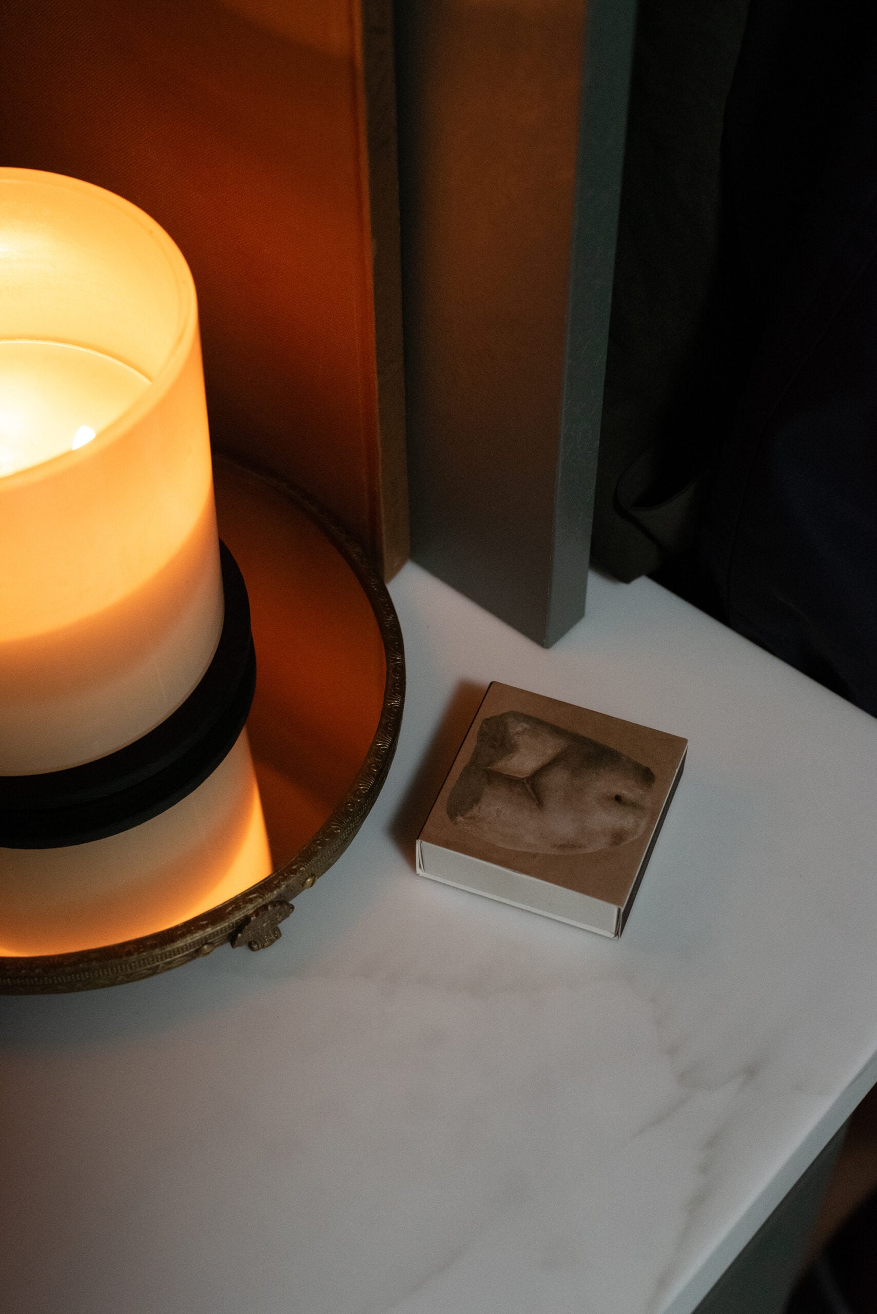 Candle on Solid Surface Countertop with Nude Matchbox