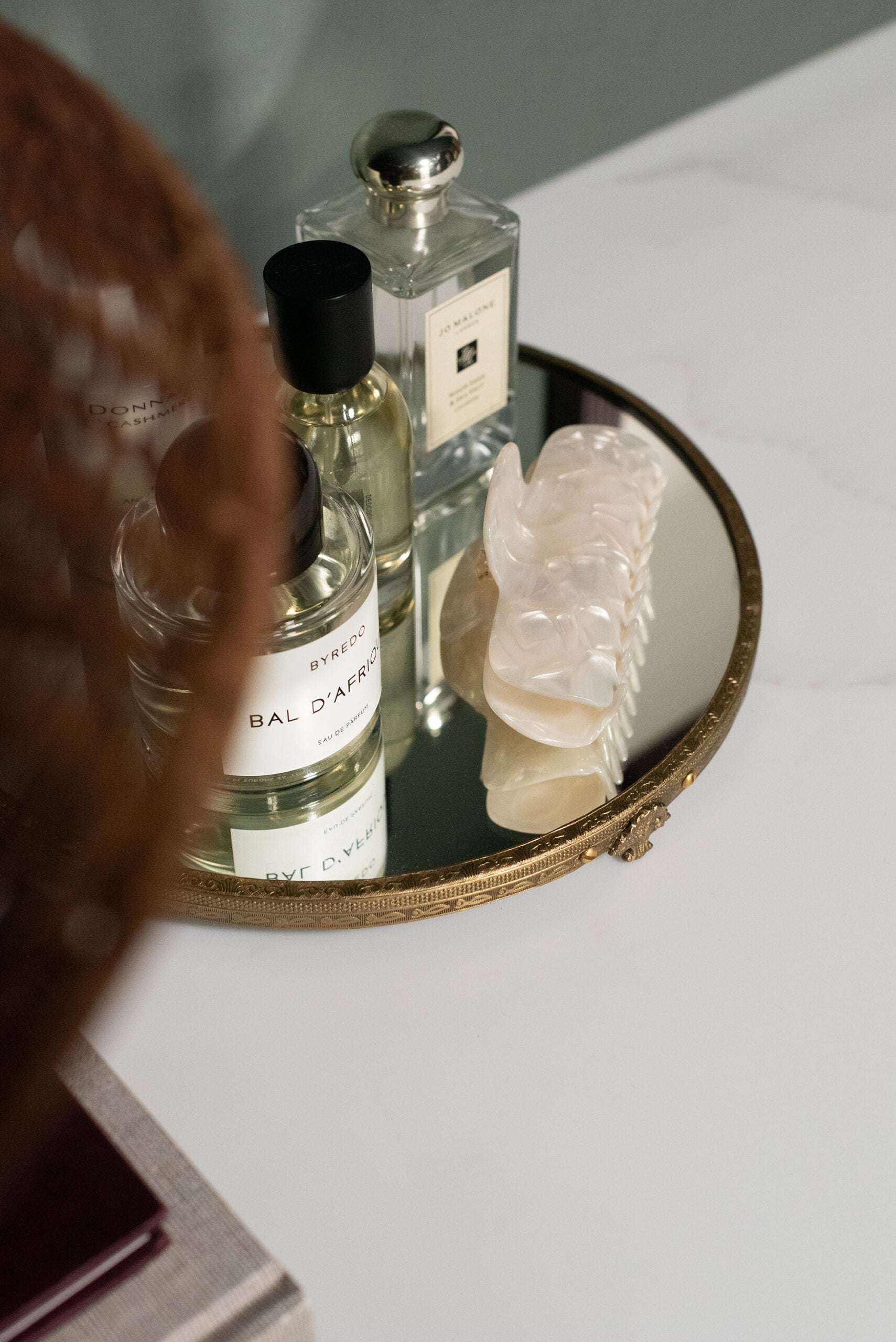 Perfumes Sitting on Mirrored Brass Pedestal Tray