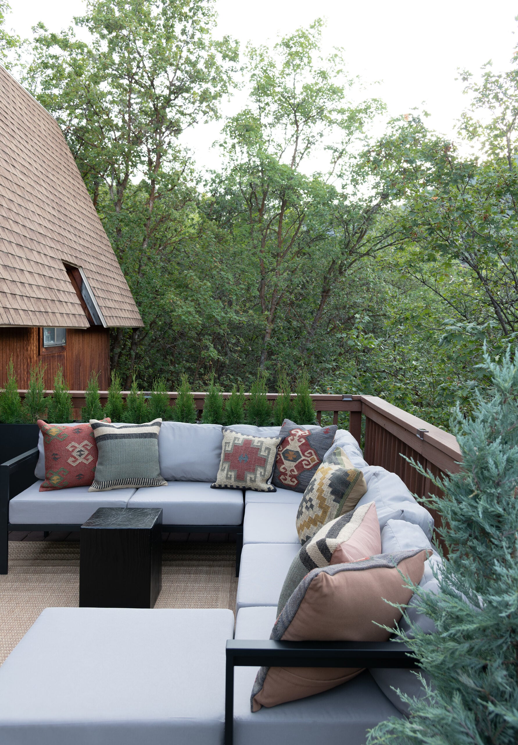 Room for Tuesday Cabin Deck with Gray Outdoor Sectional and Southwest Cushions