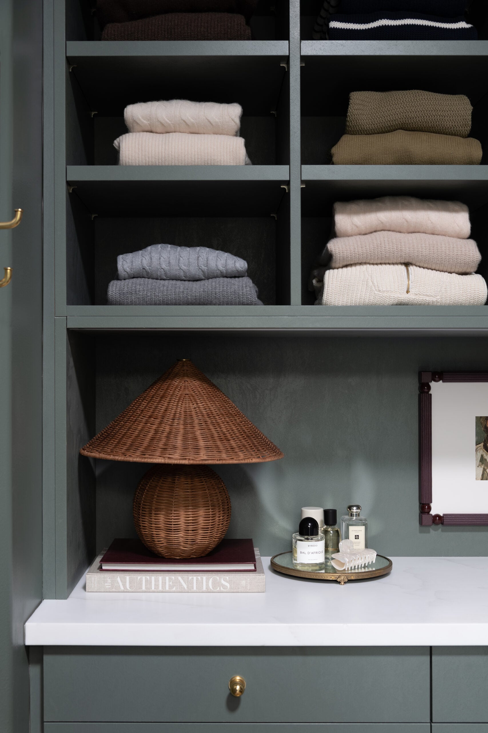 Sweaters Stacked Neatly in Dark Green Closet