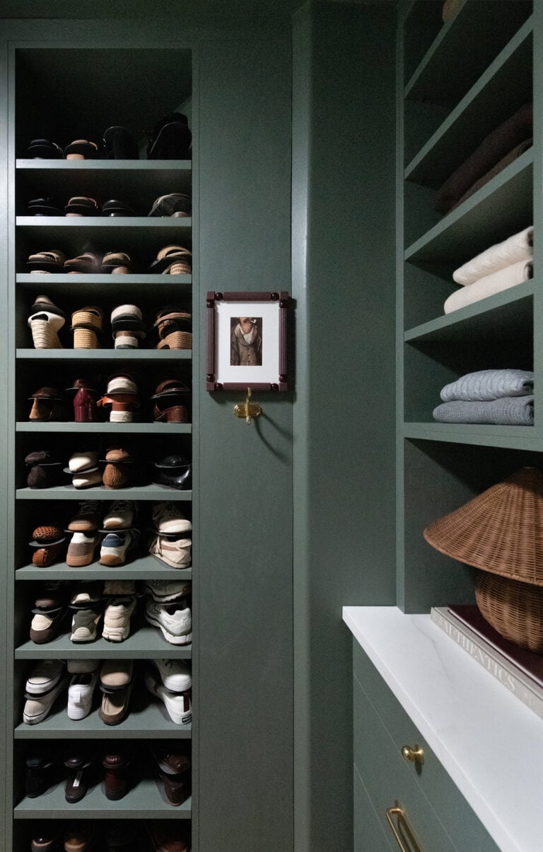 Wall of Shoes in Dark Green Walk-In Closet with Marble Countertop