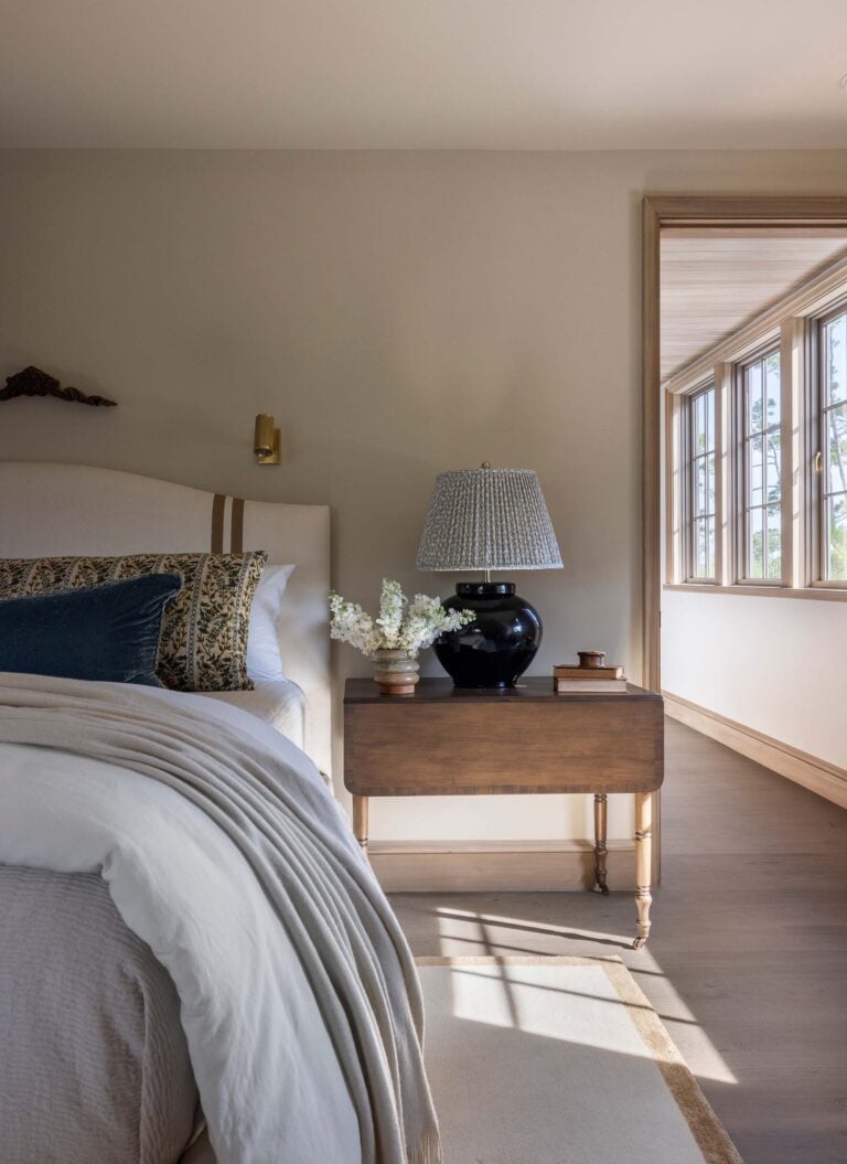 Guest Bedroom with Black Lamp on Antique Bedside Table