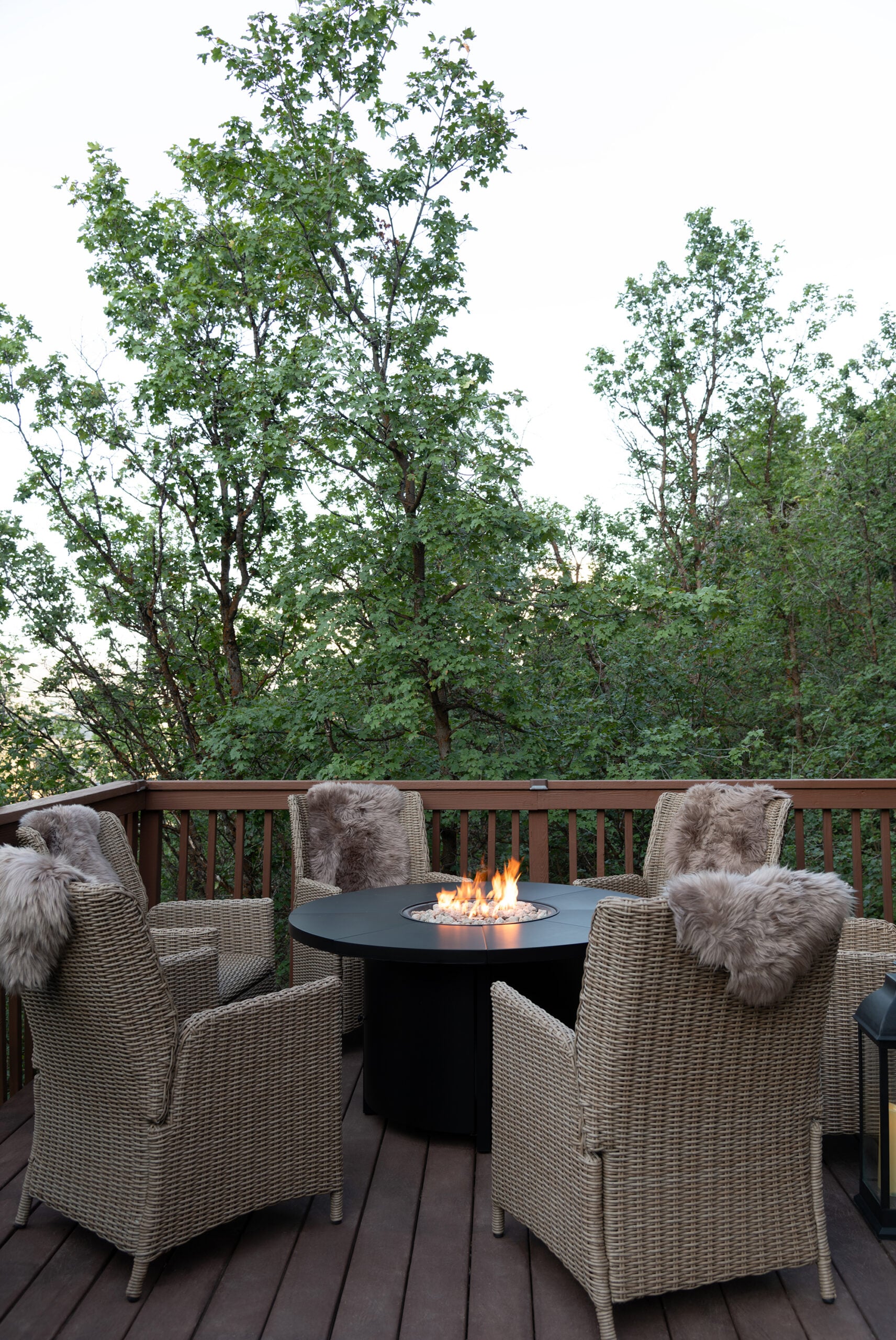 Large Fire Table with Six Woven Outdoor Chairs at Mountain Cabin