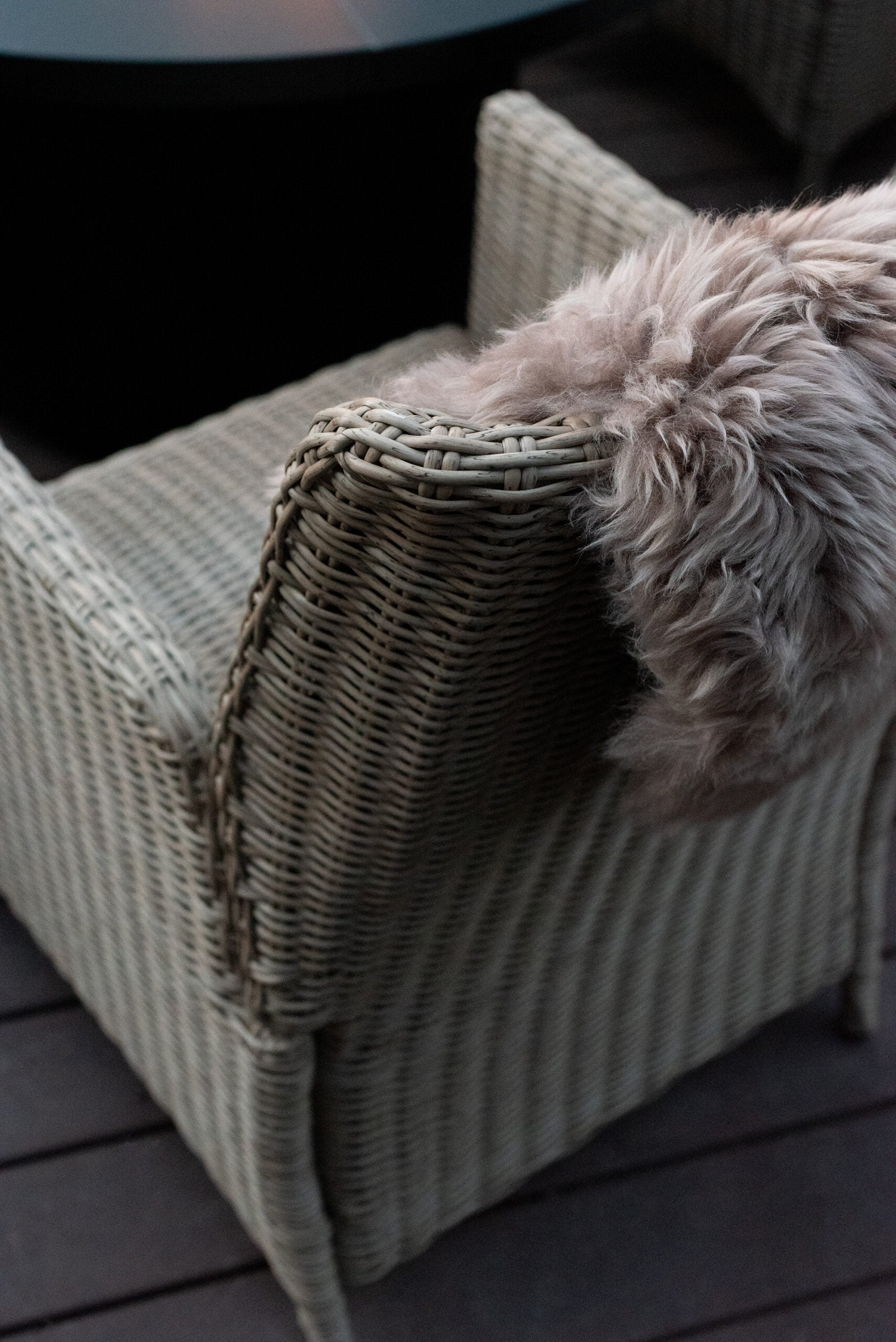 Sheepskin Draped Over Woven Outdoor Chair Around Fire Pit