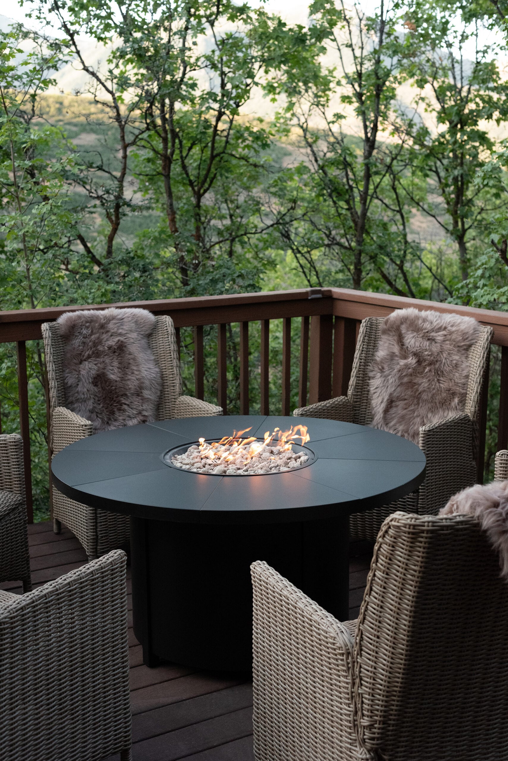 Woven Chairs Around Black Fire Pit At Mountain Cabin