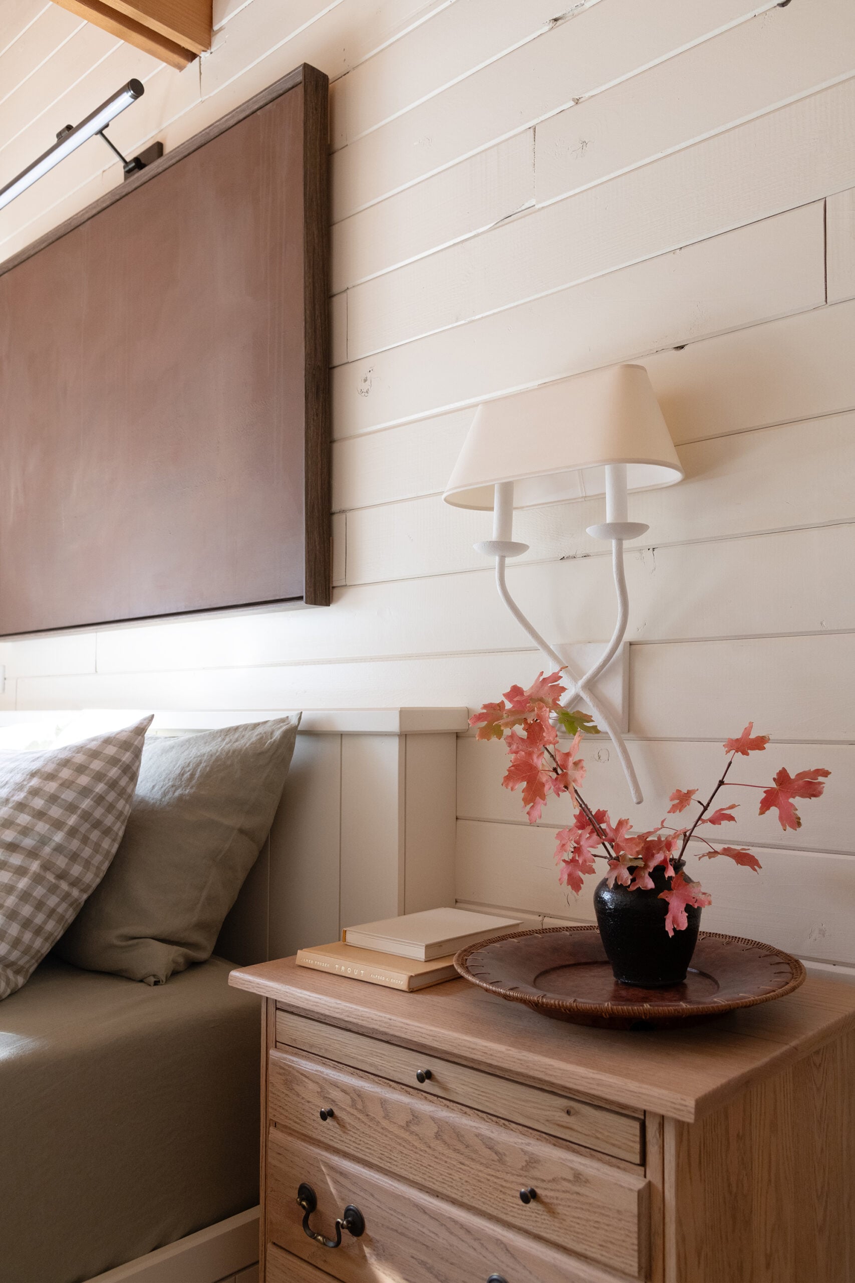 Built-In Cabin Bed with Vintage Nightstand, Sconce, and Large Art