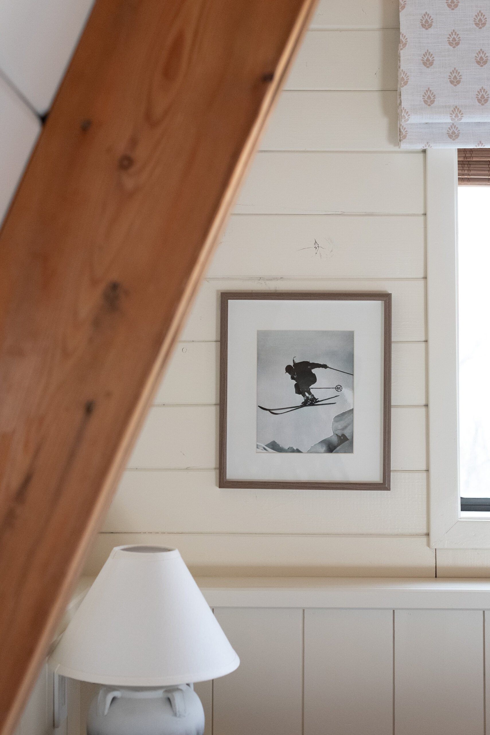 Large Beams in Cabin Bedroom with Vintage Ski Art