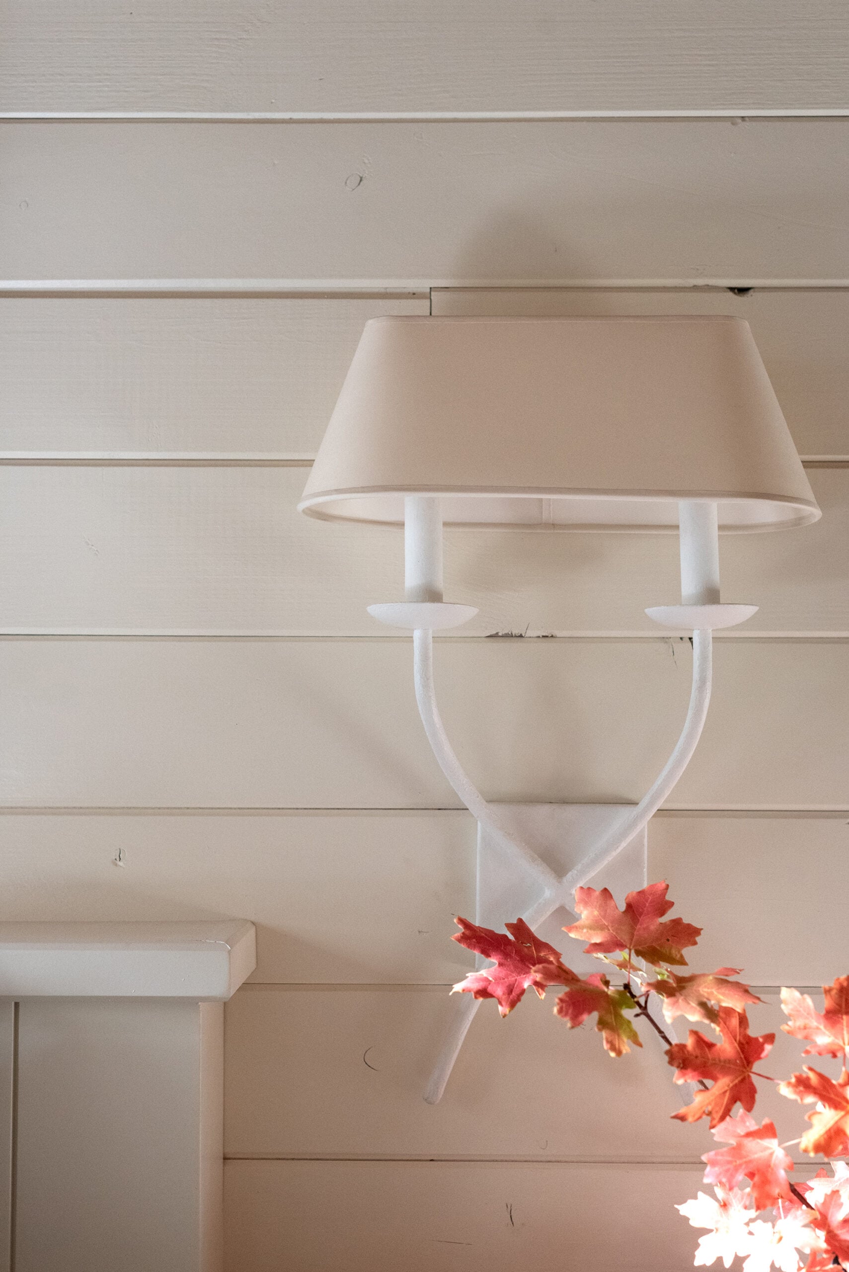 Sculptural Plaster Sconce in Cabin Bedroom with Fall Leaves